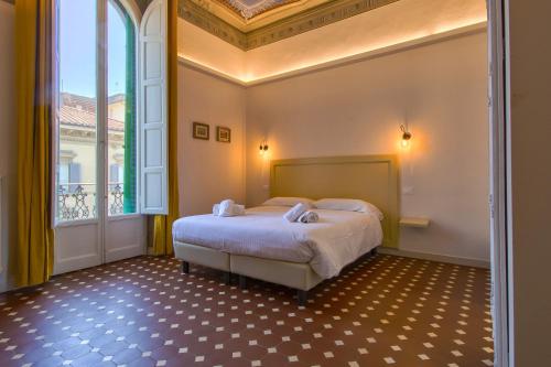 a bedroom with a bed and a large window at MOTIF 26 Pistoia in Pistoia