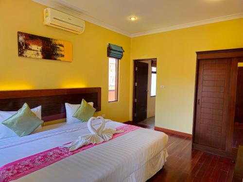 Postel nebo postele na pokoji v ubytování Baan Mesuk Hua Hin Spa and Resort