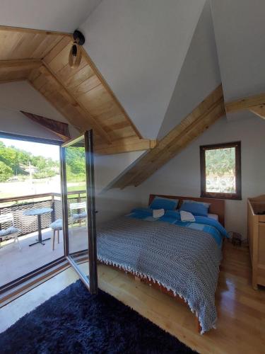 a bedroom with a bed with blue pillows at Beogradjanka mala in Zvornik