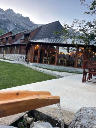 a building with a bench in front of it at Royal Land in Theth