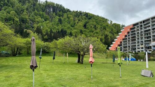 a bunch of umbrellas in a field in front of a building at Apartment am Ossiachersee mit eigenem Seezugang in Landskron