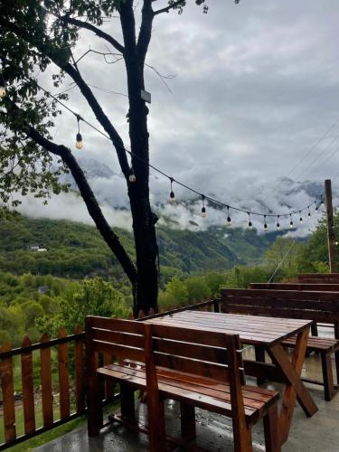 a picnic table with a view of the mountains at Royal Land in Theth