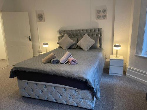 - une chambre avec un grand lit et 2 poupées dans l'établissement Luxury,Location and Convenience F3, à Bournemouth