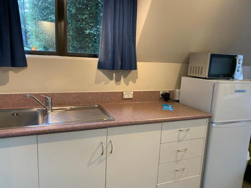 cocina con fregadero y nevera en Wakatipu View Apartments en Queenstown