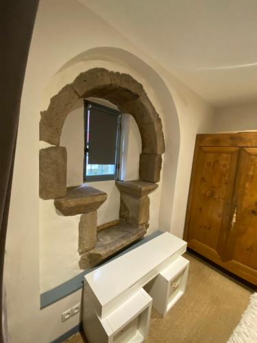 a room with a stone shelf and a window at Avélia Bonnevie in Murat
