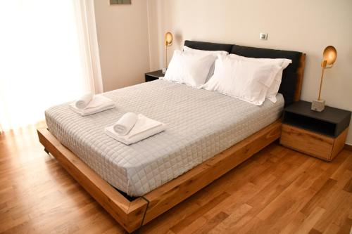 a bedroom with a bed with two towels on it at Terra Nova Luxury Villa in Mystras