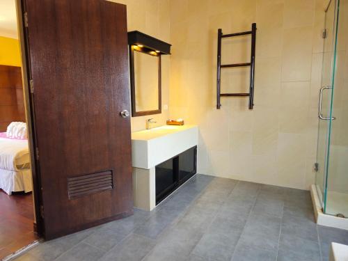 a bathroom with a sink and a mirror at Baan Mesuk Hua Hin Spa and Resort in Hua Hin