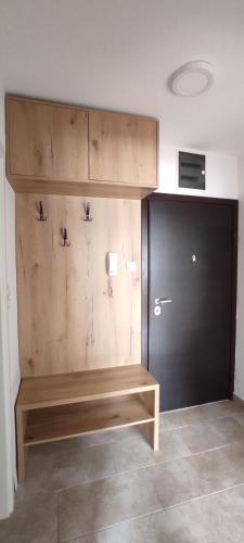een kamer met een houten bank naast een deur bij Apartman AnHel in Donje Mladice