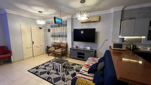 a living room with a couch and a flat screen tv at فيلا توين هاوس مميزة في قرية رويال بيتش رأس الحكمة villa twin house Royal Beach Ras El Hekma in Marsa Matruh