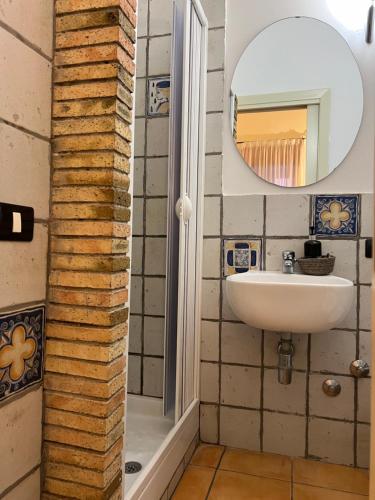 a bathroom with a sink and a mirror at La foresteria in Agrigento