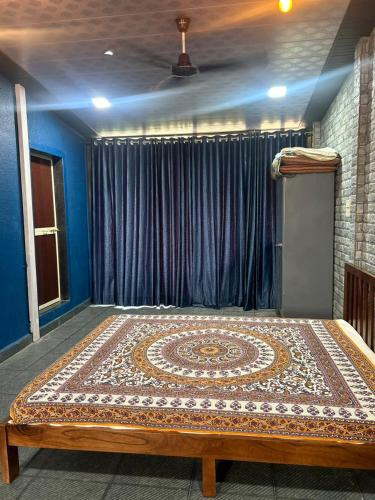 a bedroom with a bed with a rug on it at HemPriya - 3BHK wit a Private Pool in Lonavala
