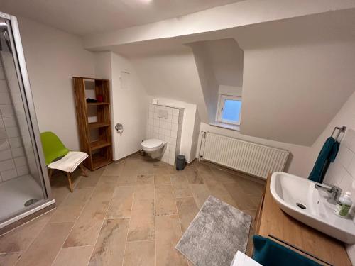 a bathroom with a shower and a toilet and a sink at Wohnen im idyllischen Schlosshof in Franken in Ebern