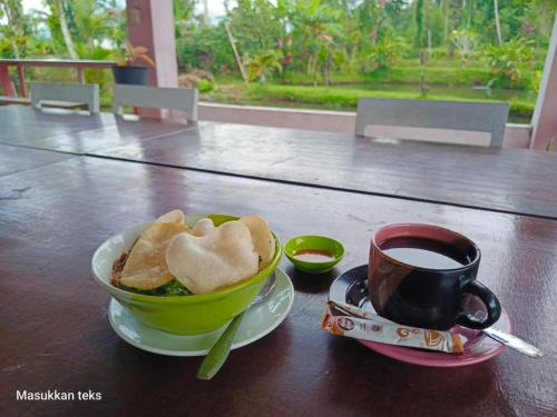 a bowl of bread and a cup of coffee on a table at Talaga Tomohon Home Stay and Fishing Pond in Tomohon