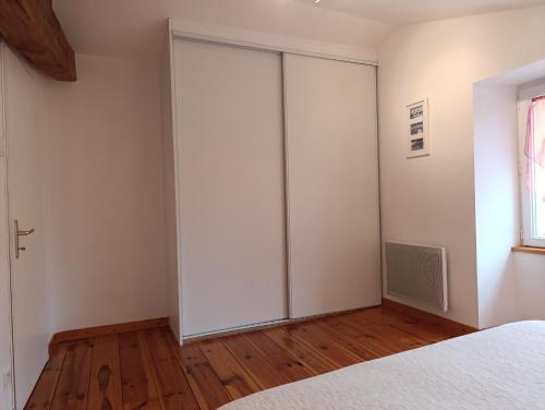 a bedroom with a sliding closet door in it at Gîtes de la Bibudière in Le Boupère