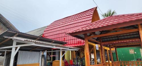 a building with a red roof on top of it at Pondok Wisata Botu Barani in Gorontalo