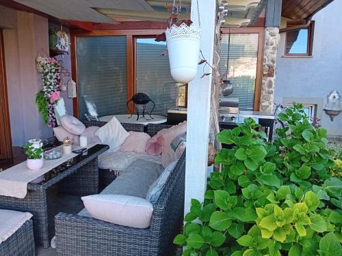 a patio with a couch and a table and chairs at Apartment Baci for 4 guests in Ljubljana