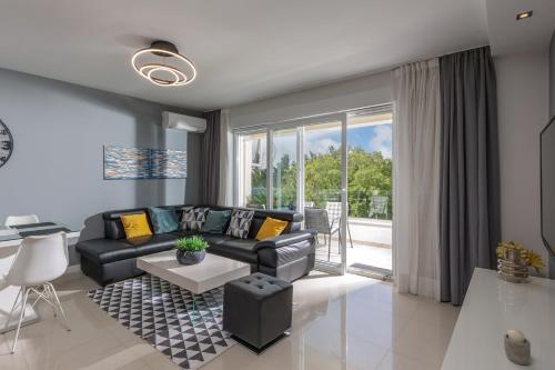 a living room with a couch and a table at Apartments Sax in Crikvenica