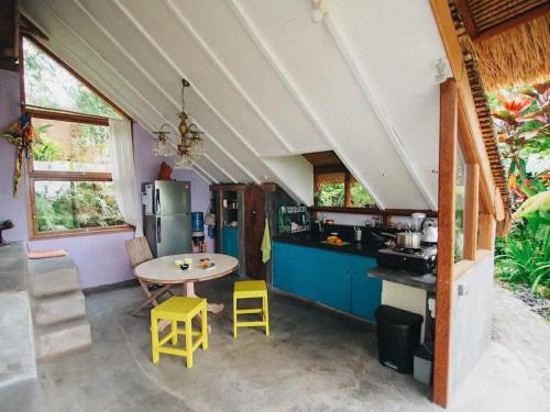 a kitchen with a table and chairs in a room at Pondok Apsari 2 in Singaraja