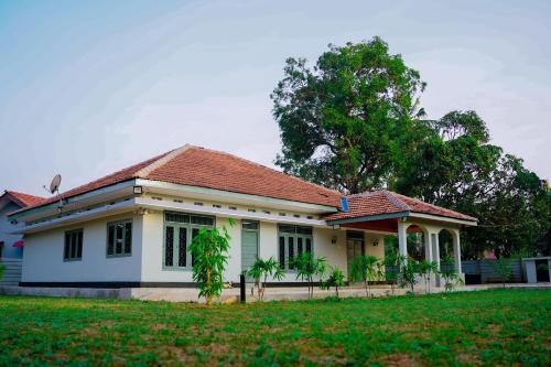 a small white house with a red roof at The Chapters in Jaffna