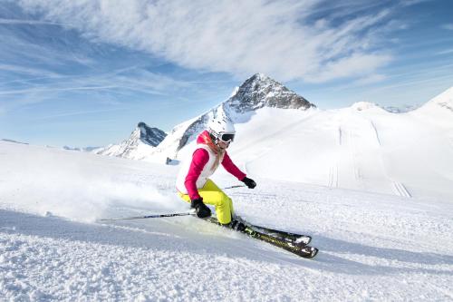 a person is skiing down a snow covered mountain at Haus Sonnegg in Finkenberg