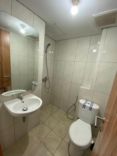 Minimalist room at The Nest Apartment by Popobella Near Puri Indah West Jakarta