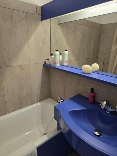 a bathroom with a sink and a mirror and a tub at Magic mer in Saint-Raphaël