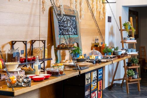 a buffet with food on a wooden table at Hotel Memories OldTown in Budapest