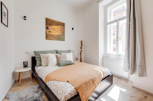 a bedroom with a bed and a window at Romantic apartment by the park - uaka7 in Prague