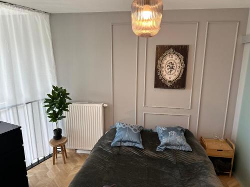 a bedroom with a bed with two pillows on it at Apartamenty Zamość Sienkiewicza in Zamość