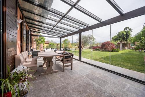 an outdoor patio with a pool table and glass doors at Cascina Girba in Giaveno