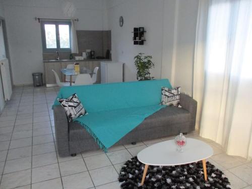 a living room with a couch and a table at House in vineyard in Emboríon