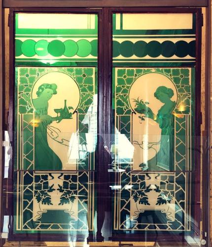 a window with two women in the reflection at ANERI in Ljubljana