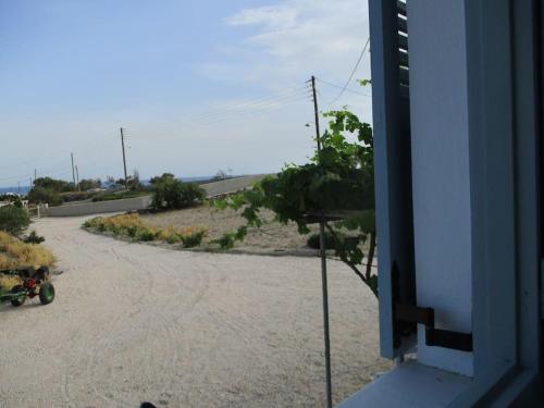 a motorcycle parked on the side of a road at House in vineyard in Emboríon