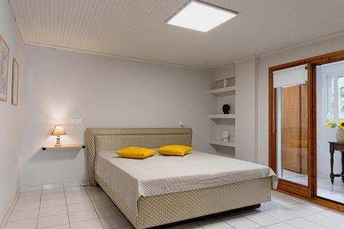 um quarto com uma cama com duas almofadas amarelas em Arches em Agria