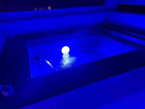 a pool of blue water with a lit candle in it at SuiteFrattini Private Spa Rooftop in Rome
