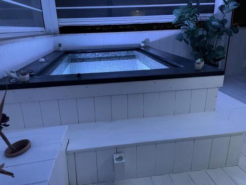 a hot tub in a room with a window at SuiteFrattini Private Spa Rooftop in Rome