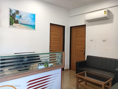 a living room with a tv and a couch at Hotel Suryaprabha- Near Diveagar Beach in Diveagar