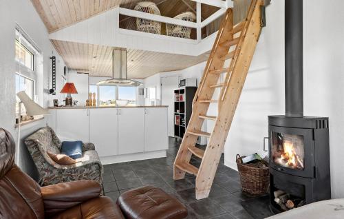 a living room with a fireplace and a loft at Beach Front Home In Børkop With Wifi in Børkop