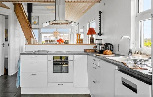 a kitchen with white cabinets and a sink at Beach Front Home In Børkop With Wifi in Børkop