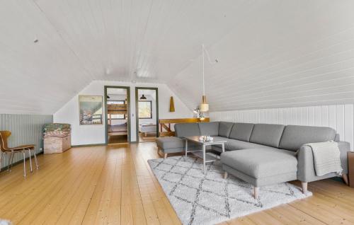 a living room with a couch and a table at 3 Bedroom Beautiful Home In Ørsted in Ørsted