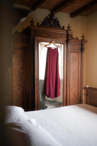 a dress hanging in a window in a bedroom at Ca'Os Locanda&Grill in Vigostano