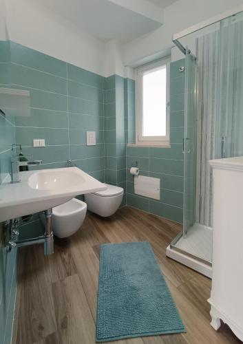 a bathroom with a sink and a toilet and a shower at Wishing & Dreaming Sperlonga in Sperlonga
