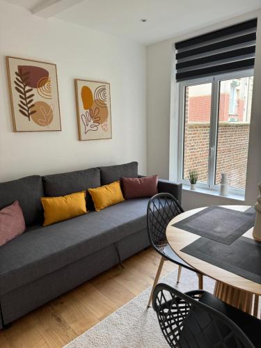 a living room with a couch and a table at Victorias House Suite in Lille