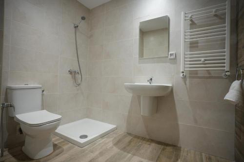 a bathroom with a toilet and a sink at Le Bleu Panaché in Sfax