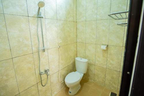 a bathroom with a toilet and a shower at Ranya Homestay in Purwokerto