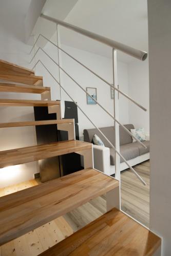 a living room with stairs and a couch in a house at Wishing & Dreaming Sperlonga in Sperlonga