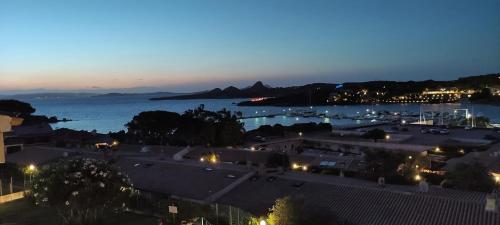 a view of a city with a harbor at night at Blue Bay Apartment in Cala Bitta