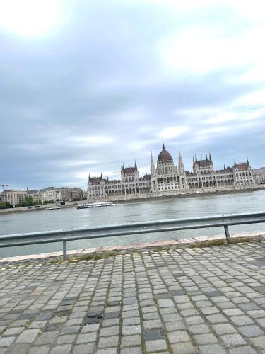 a large building on the water next to a river at Studio Viva - Cosy Flat in Budapest - Free Parking in Budapest