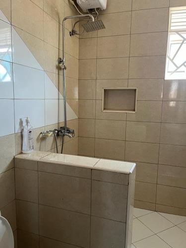 a bathroom with a sink and a shower at Vero Homes in Buwate