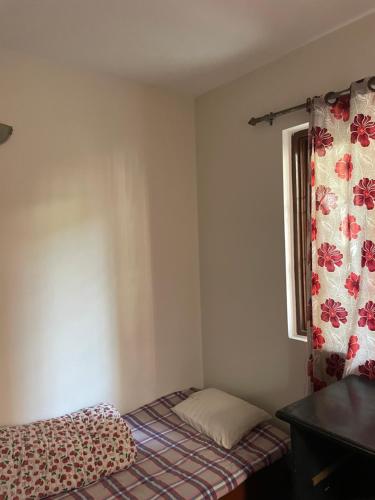 a small room with a bed and a window at Kasaa Home in Pātan